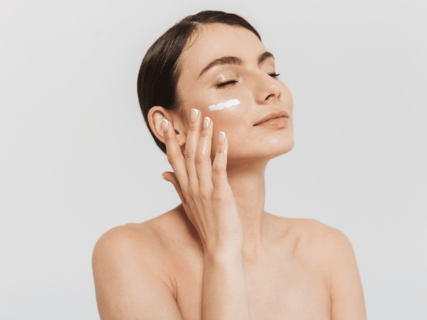 woman applying personalised cream on her cheek